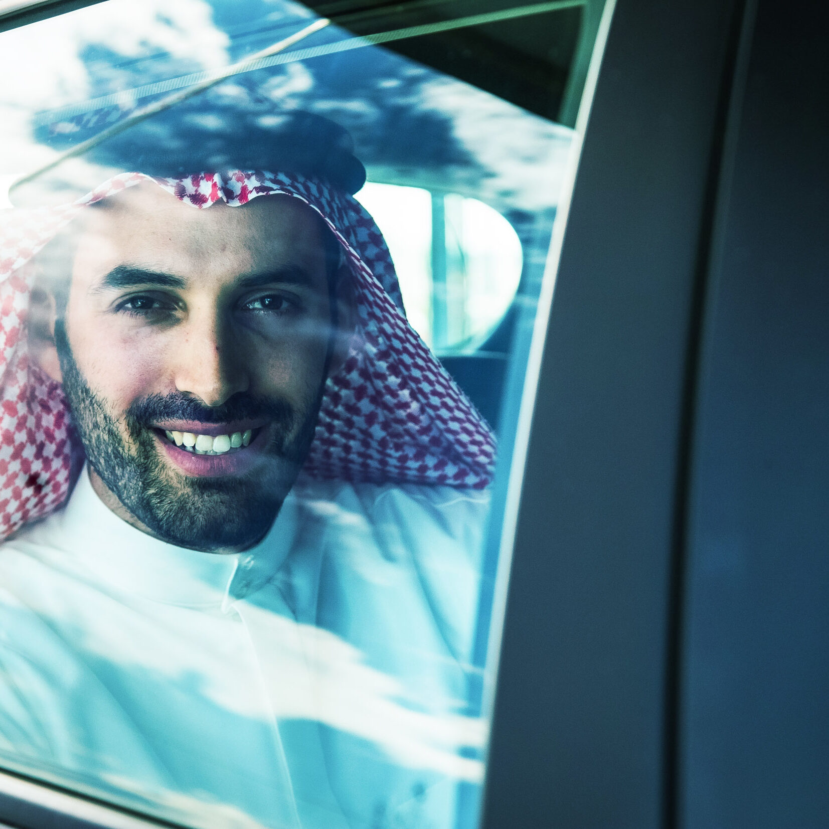 Man from Saudi looking out car window